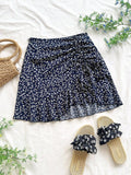 MINI FALDA AZUL CON FLORES BLANCAS