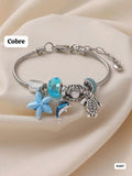 PULSERA PLATEADA CON DIJES TONOS CELESTESZ